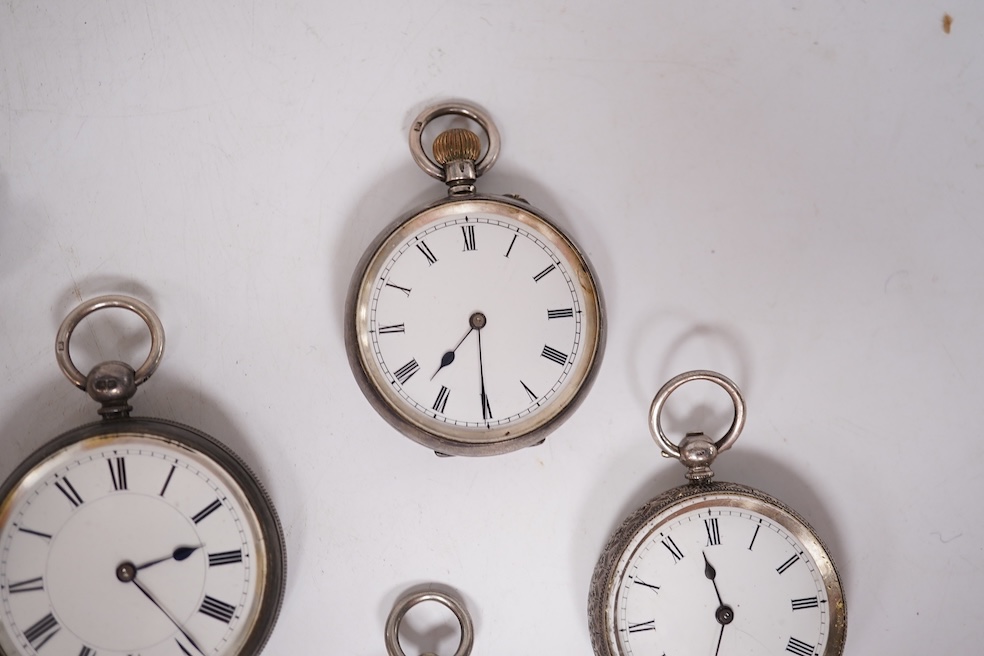 Three early to mid 20th century silver open faced pocket watches, with Roman or Arabic dials and subsidiary seconds, including two keyless and one key wind (Admiral Tacy Watch Co), together with one smaller silver open f